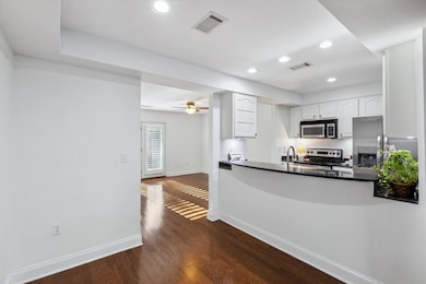 Kitchen featuring baseboards, visible vents, appli