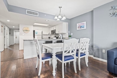 Dining space featuring an inviting chandelier, sin