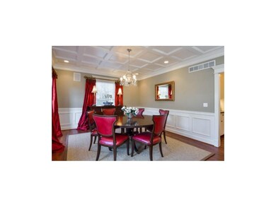 Coffered ceiling and gorgeous wainscoting in this 