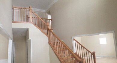 Two-story foyer with oak railing