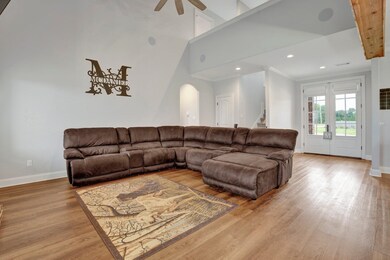 Living room with light hardwood / wood-style floor