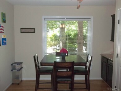 Dining Area with Large Window Overlooking Front Ya