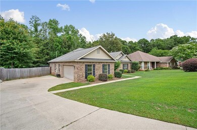 View of front of property featuring brick siding, concrete driveway, and an attached garage