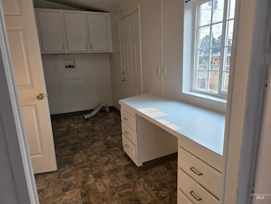 Unfurnished office with built in study area and stone finish floors