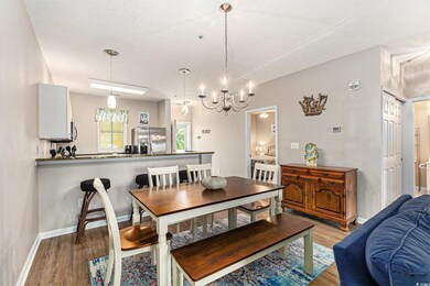 Dining space featuring light wood-style flooring, a chandelier, and baseboards
