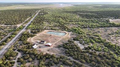 Aerial overview of property's location with a large body of water and rural landscape