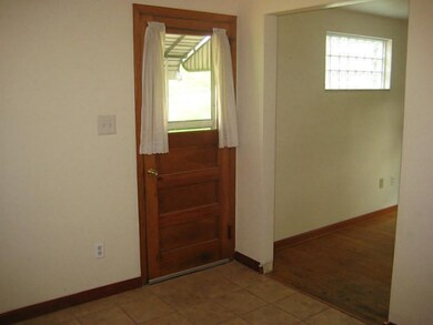 Kitchen. A door leads to the covered side porch.