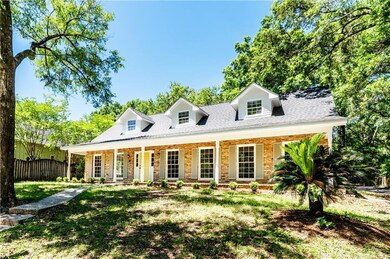 Cape cod home with a porch, a shingled roof, brick