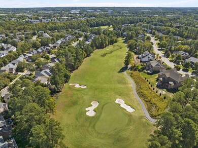 The home is to the right of the green