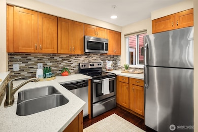 Well appointed and designed kitchen with quartz counters, stainless appliances, dishwasher, microwave and glass stove top range.