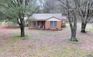 Single story home with a porch and brick siding