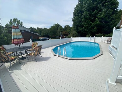 Pool surrounded by vinyl deck with room for table,