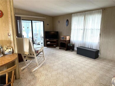Carpeted living area featuring lofted ceiling, ple