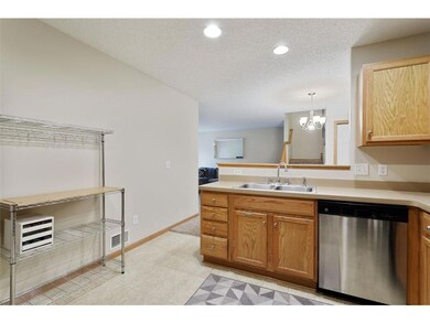 Kitchen sink overlooks dining room and living room