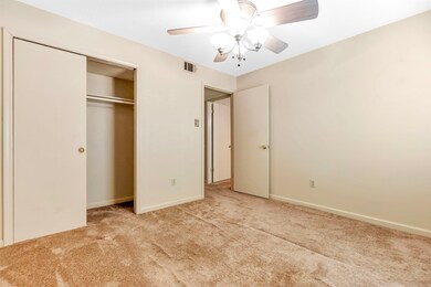 Unfurnished bedroom with a closet, baseboards, car