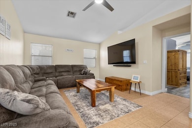 Living room featuring ceiling fan, lofted ceiling,