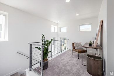 Bright and open, this loft is your bonus room for work, creativity, or chill time. *Model Home Photo.