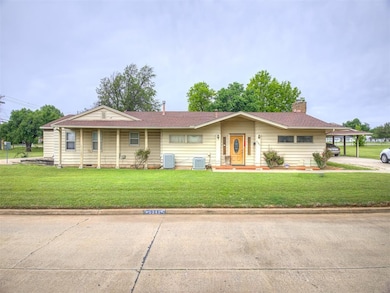 View of front of house featuring central AC, a front lawn, a chimney, and a shingled roof