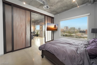 Bedroom featuring finished concrete flooring