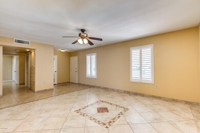Living Room, Foyer, and Coat Closet with Plantation Shutters, shelve, ceiling fan, and tile floors!