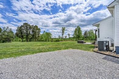 Rear view of house with an outdoor hangout area, c