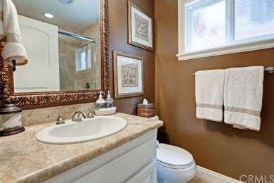 Full bathroom with a shower wrapped in travertine 