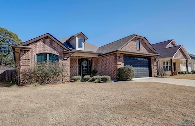 French country inspired facade featuring brick sid