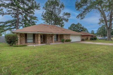 Single story home featuring a garage and a front l