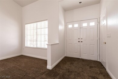 Foyer featuring dark colored carpet and baseboards