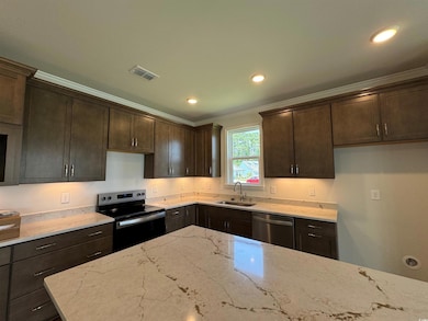 Kitchen with sink, ornamental molding, light stone