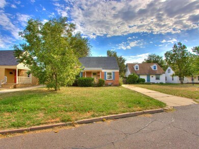 View of front of house with a front yard and a por