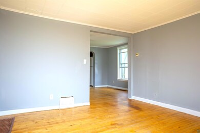 Empty room with crown molding and light wood-type 