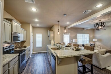 Kitchen with stainless steel appliances, open floo