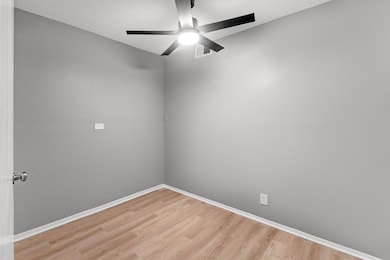 Unfurnished room with visible vents, light wood f