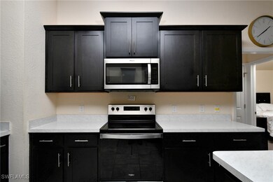 Kitchen with stainless steel appliances and ornamental molding