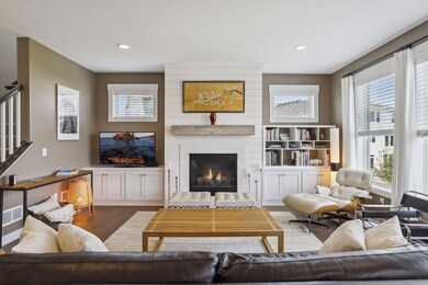 The family room is a large main level gathering space which centers around a gas fireplace. Like the rest of the main level it features engineered hardwood flooring. It also includes recessed lighting, several windows and built in storage.