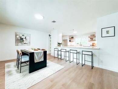 Another view of the living room and entry from the kitchen.