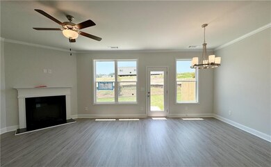 Unfurnished living room featuring crown molding, w