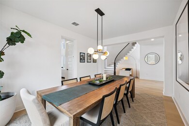Dining space with stairway, light wood finished f