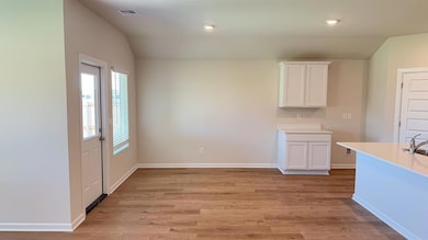 Unfurnished dining area with light wood-type flooring, lofted ceiling, and recessed lighting