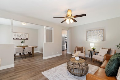 Living area featuring wood finished floors and ceiling fan