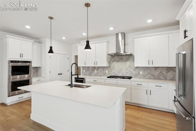 Kitchen with a center island with sink, pendant li