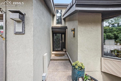 Entrance to property with stucco siding