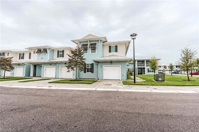 Multi unit property featuring an attached garage, stucco siding, driveway, and a front yard