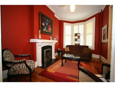 Three window bay with plantation shutters fills th
