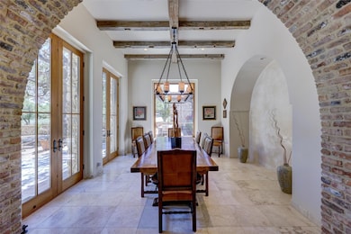 Dining area featuring beamed ceiling, baseboards,