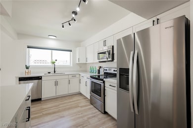 Kitchen featuring stainless steel appliances, ligh