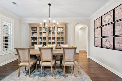Dining area featuring a notable chandelier, crown 