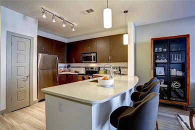 Kitchen featuring track lighting, stainless steel 