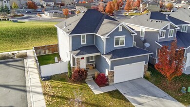 View of front facade with a residential view, stone siding, a shingled roof, concrete driveway, and a garage